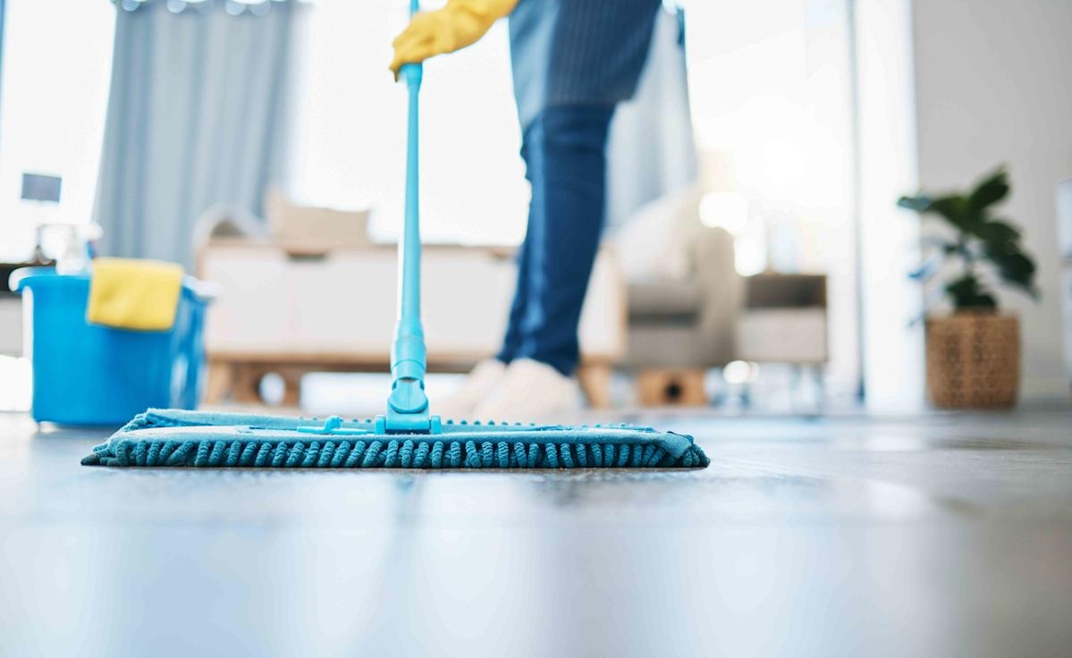 office cleaning company perth staff in uniform mopping hard floor